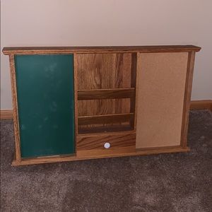 A shelf with a chalk board and cork board